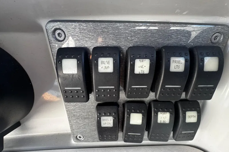 Slide: The Image of Control panel switches on a 2004 Formula 280 Sun Sport boat dashboard. - 12