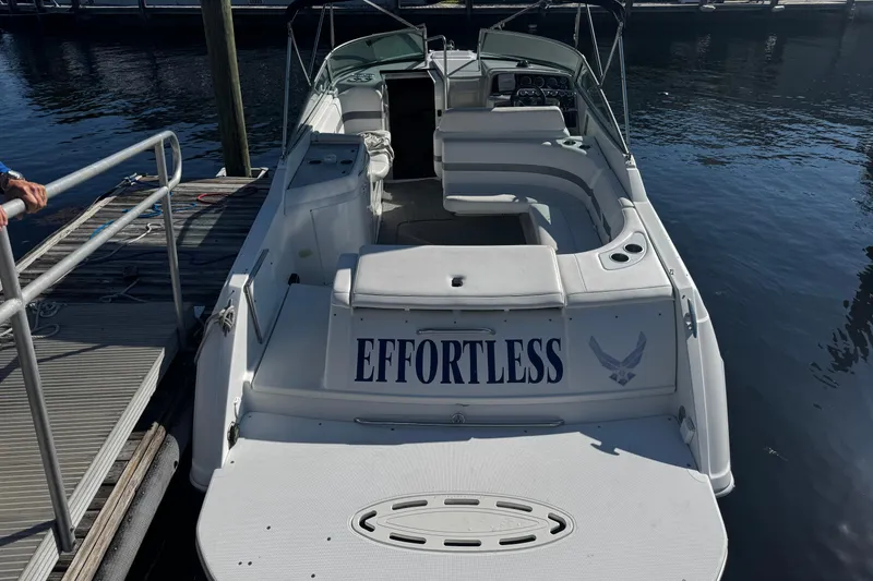 Slide: The Image of 2004 Formula 280 Sun Sport boat named "Effortless" docked at a marina. - 2