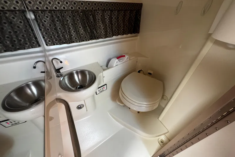 Slide: The Image of 2004 Formula 280 Sun Sport boat bathroom with dual sinks and toilet. - 20
