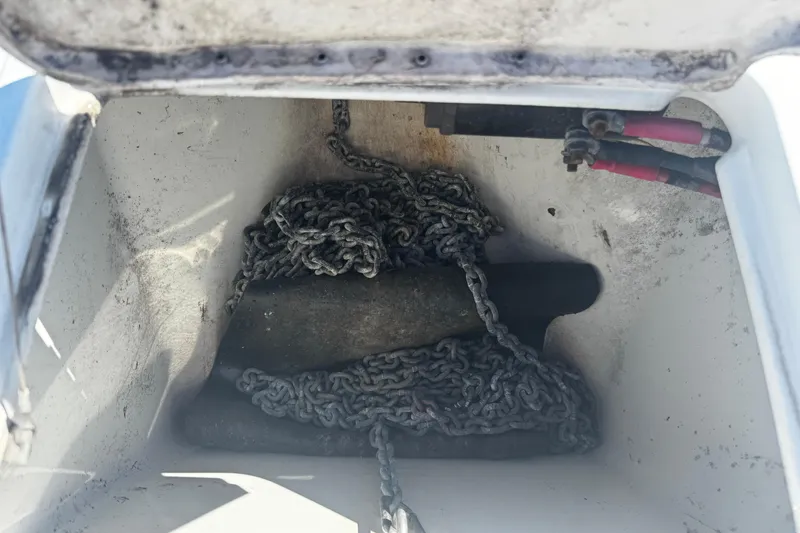 Slide: The Image of Anchor chain storage in a 2004 Formula 280 Sun Sport boat compartment. - 22
