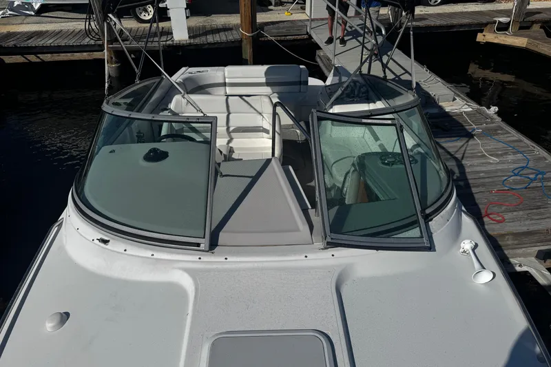 Slide: The Image of 2004 Formula 280 Sun Sport boat docked, featuring open cockpit and windshield. - 23