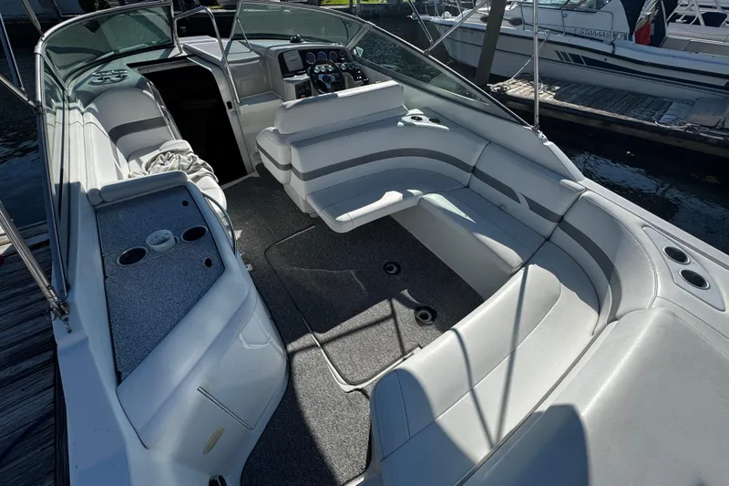 Slide: The Image of 2004 Formula 280 Sun Sport boat interior with seating and dashboard, docked at marina. - 4