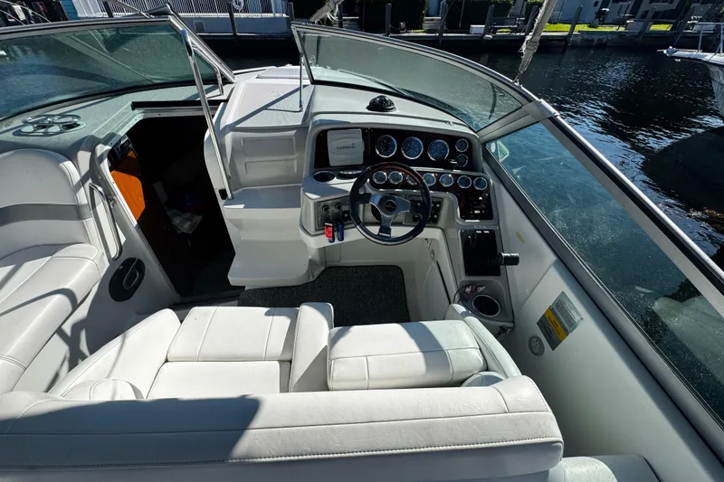 Slide: The Image of 2004 Formula 280 Sun Sport boat interior with steering wheel and dashboard controls. - 8