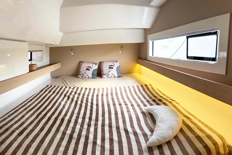 Slide: The Image of Cozy cabin interior of 2026 Aventura 37 Explorer Trawler with striped bedding and modern lighting. - 19