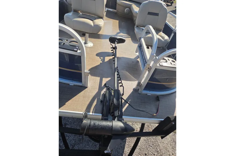 Slide: The Image of 2021 Sun Tracker Bass Buggy 16 XL pontoon boat interior with seating and motor. - 16