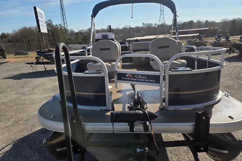 Slide: The Image of 2021 Sun Tracker Bass Buggy 16 XL pontoon boat in outdoor dealership setting. - 2