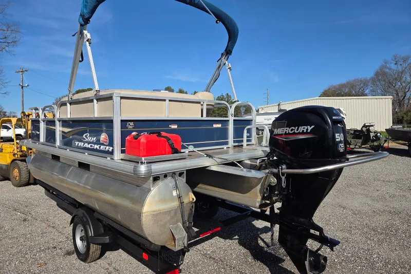 Slide: The Image of 2021 Sun Tracker Bass Buggy 16 XL pontoon boat with Mercury 50 engine on trailer. - 7