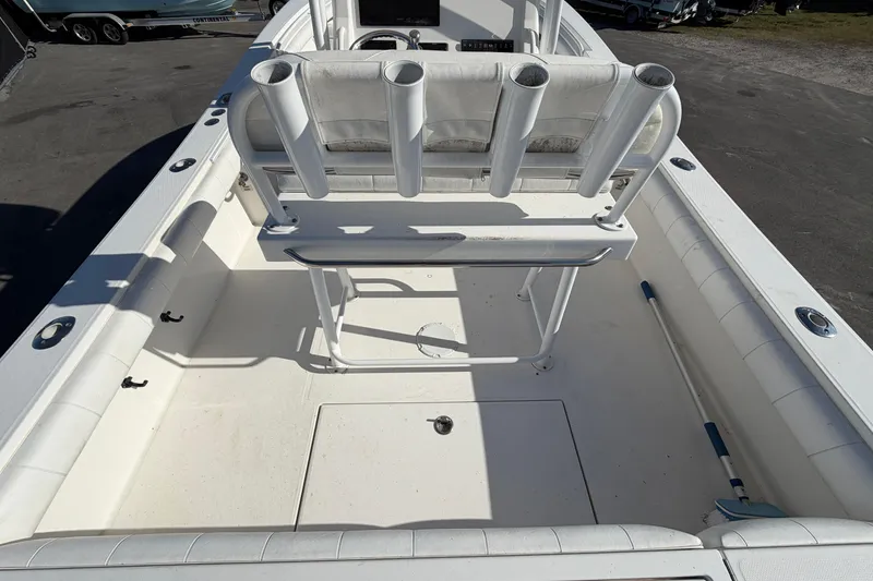 Slide: The Image of 2013 Regulator 24 Forward Seating boat on trailer under sunny sky. - 11