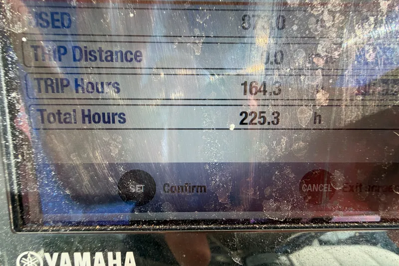 Slide: The Image of 2013 Regulator 24 Forward Seating boat interior with white seating and storage compartments. - 15