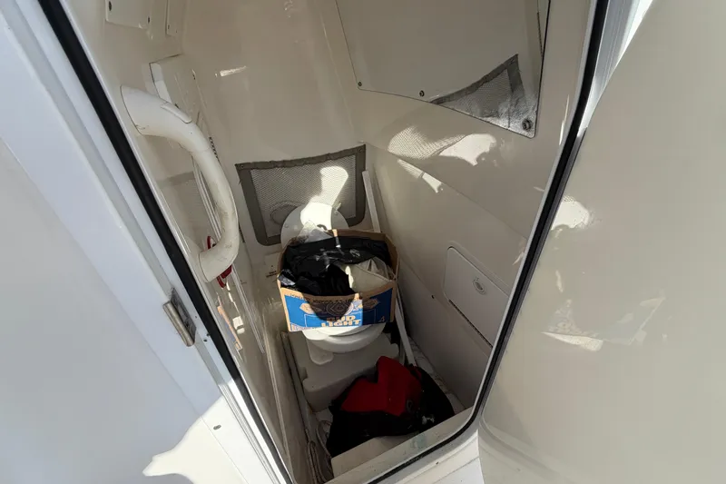 Slide: The Image of 2013 Regulator 24 Forward Seating boat with rod holders, docked under clear skies. - 17