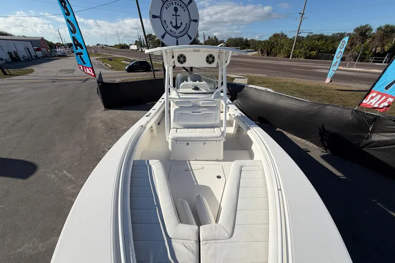 Slide: The Image of 2013 Regulator 24 Forward Seating boat interior with rod holders and steering console. - 21