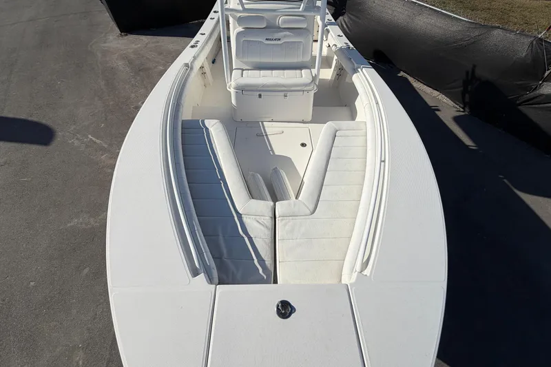 Slide: The Image of 2013 Regulator 24 Forward Seating boat dashboard with navigation display, steering wheel, and controls. - 22