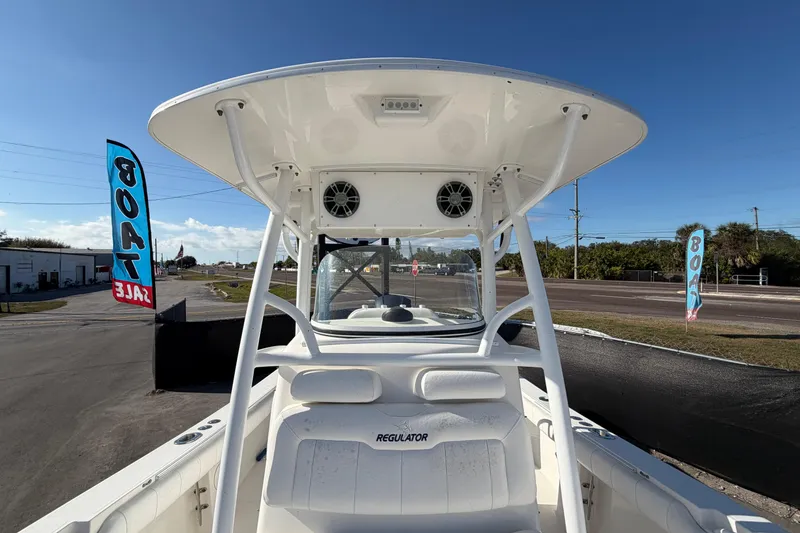 Slide: The Image of 2013 Regulator 24 Forward Seating boat cockpit with steering wheel and navigation display. - 23