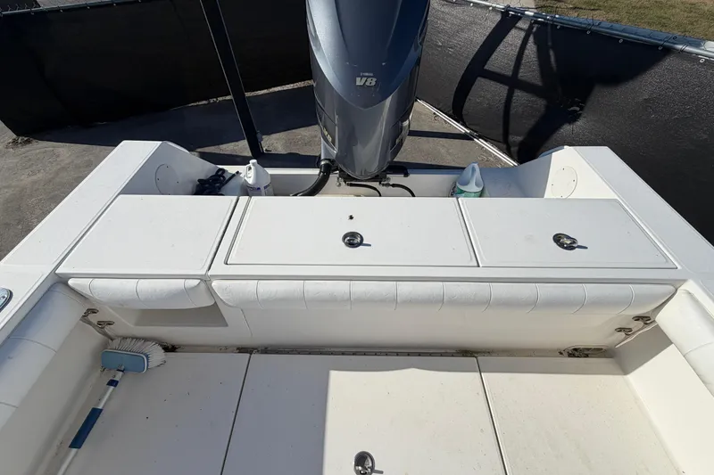 Slide: The Image of 2013 Regulator 24 Forward Seating boat dashboard with navigation display, parked in a marina. - 26