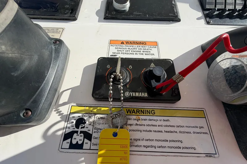 Slide: The Image of 2013 Regulator 24 Forward Seating boat console detail with red coiled cord. - 39