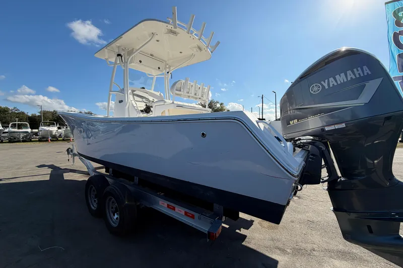 Slide: The Image of 2013 Regulator 24 Forward Seating boat with V8 350 engine, displayed outdoors. - 4