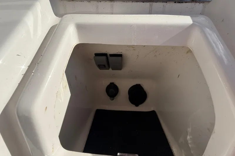 Slide: The Image of 2013 Regulator 24 Forward Seating boat storage compartment, white interior detail. - 42
