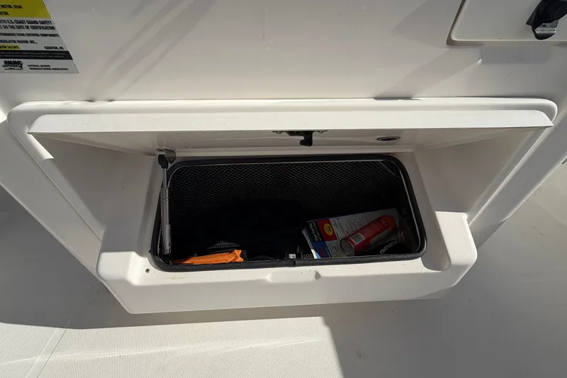 Slide: The Image of 2013 Regulator 24 Forward Seating boat interior with white cushioned seats. - 44