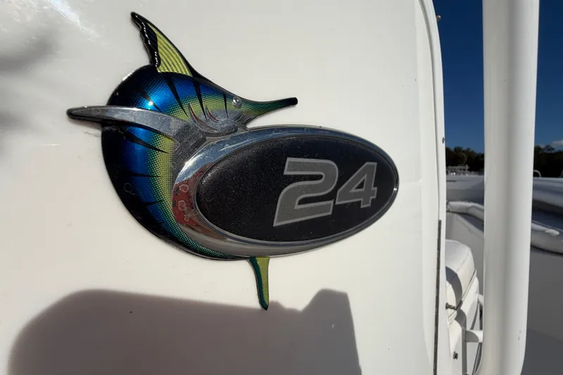 Slide: The Image of 2013 Regulator 24 Forward Seating boat with open restroom door, showing interior toilet. - 47