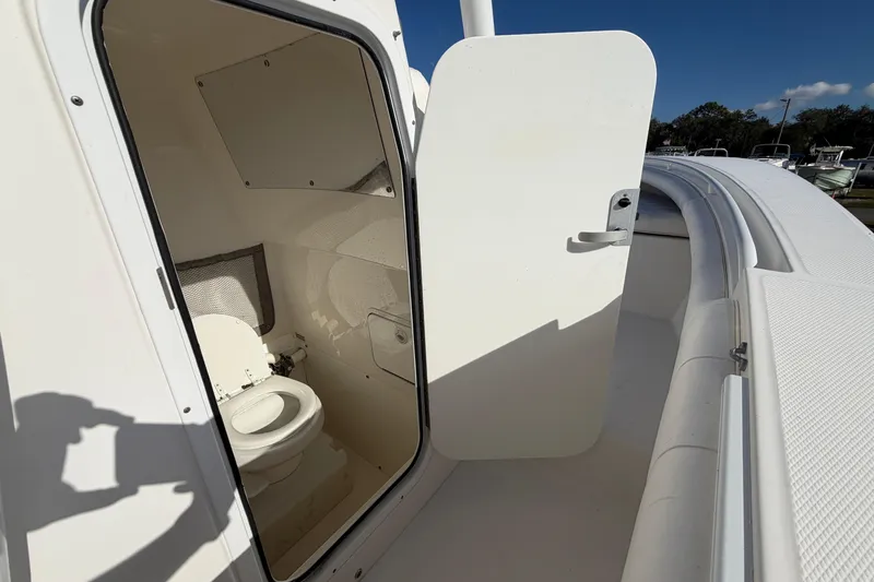 Slide: The Image of 2013 Regulator 24 Forward Seating boat interior with marine toilet. - 48