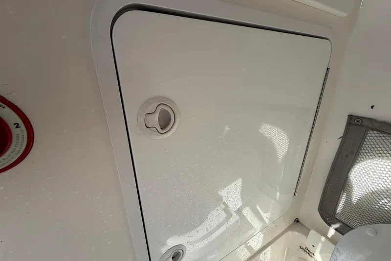 Slide: The Image of 2013 Regulator 24 Forward Seating boat electrical compartment with wiring and battery setup. - 51