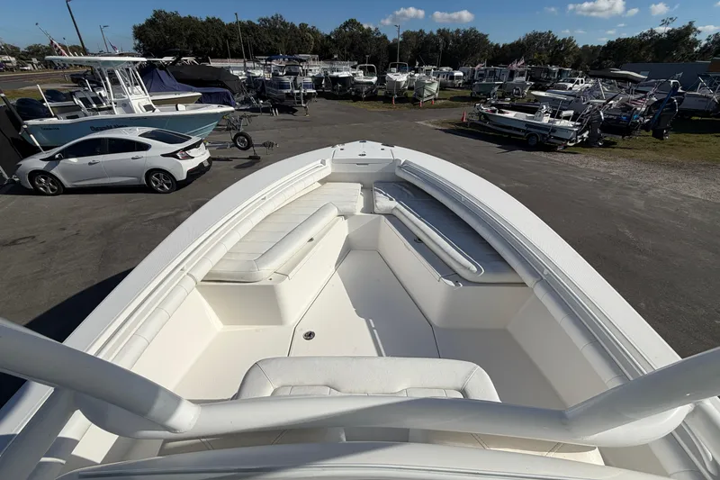 Slide: The Image of 2013 Regulator 24 Forward Seating boat with white cushioned seats. - 53