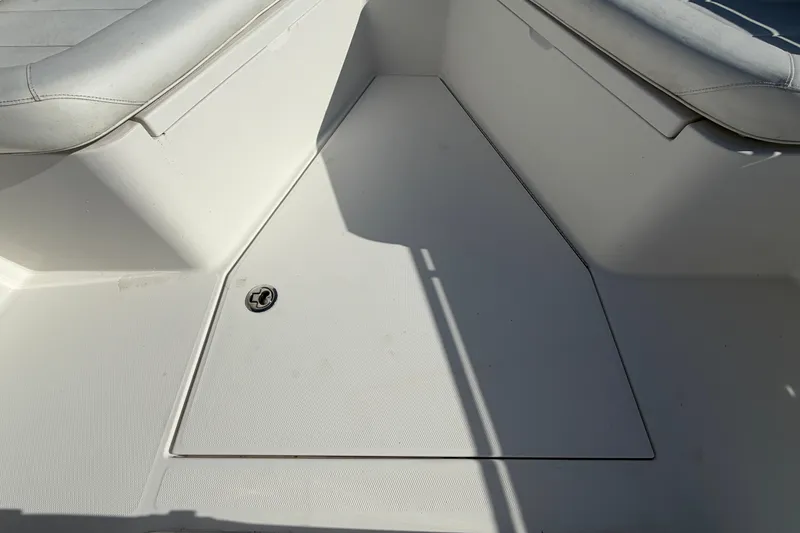 Slide: The Image of 2013 Regulator 24 Forward Seating boat with open storage compartment. - 55