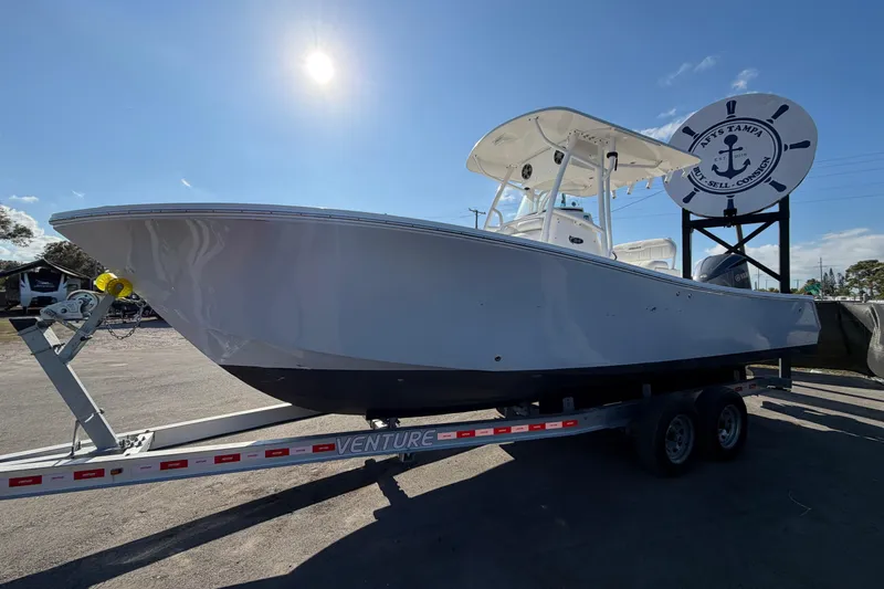 Slide: The Image of 2013 Regulator 24 Forward Seating boat with V8 350 engine, parked outdoors. - 6