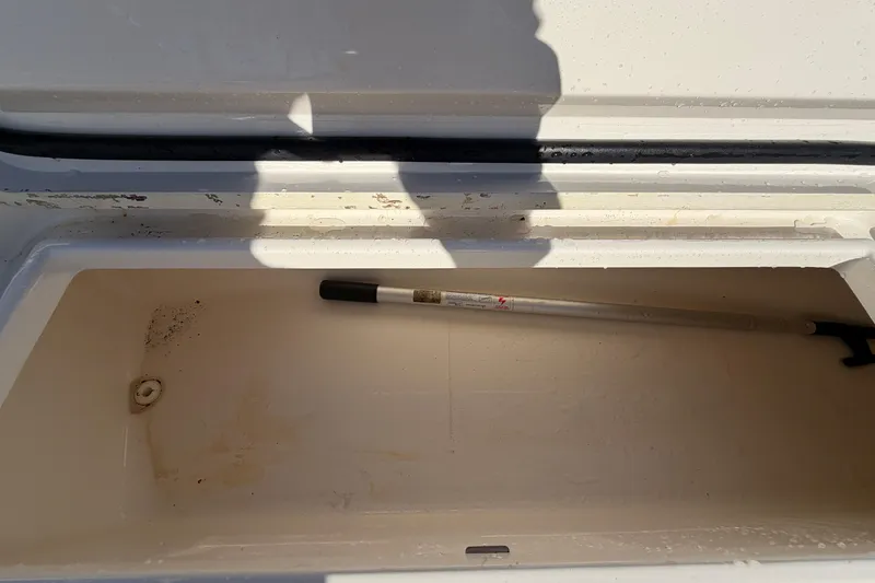 Slide: The Image of 2013 Regulator 24 Forward Seating boat interior with storage compartment. - 60