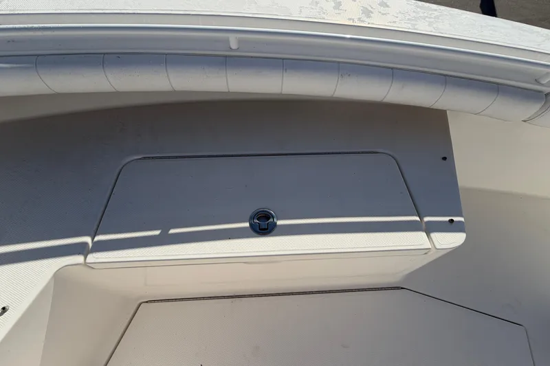 Slide: The Image of Open storage compartment on 2013 Regulator 24 Forward Seating boat. - 61