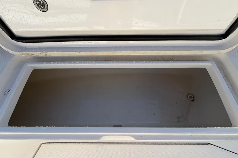 Slide: The Image of 2013 Regulator 24 Forward Seating boat deck with storage compartments and seating. - 63