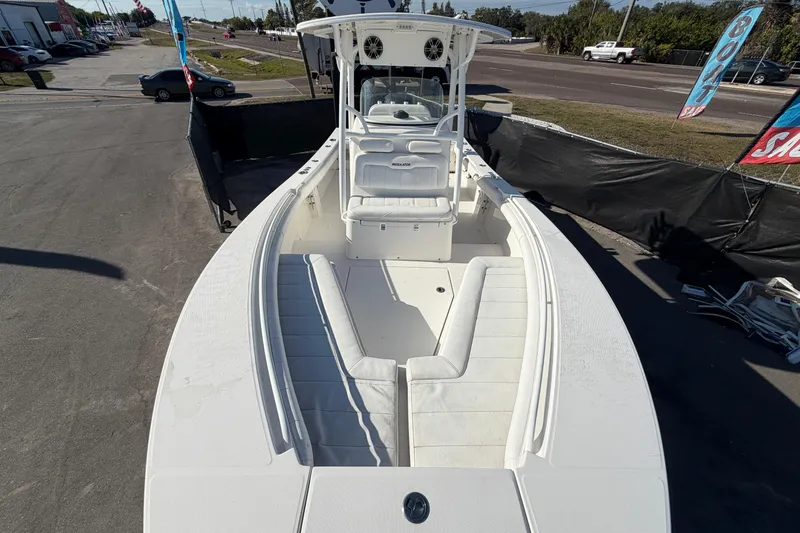 Slide: The Image of 2013 Regulator 24 Forward Seating boat with spacious white interior and seating arrangement. - 67