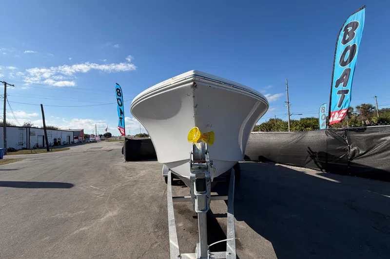 Slide: The Image of 2013 Regulator 24 Forward Seating boat propeller close-up in a parking lot. - 7