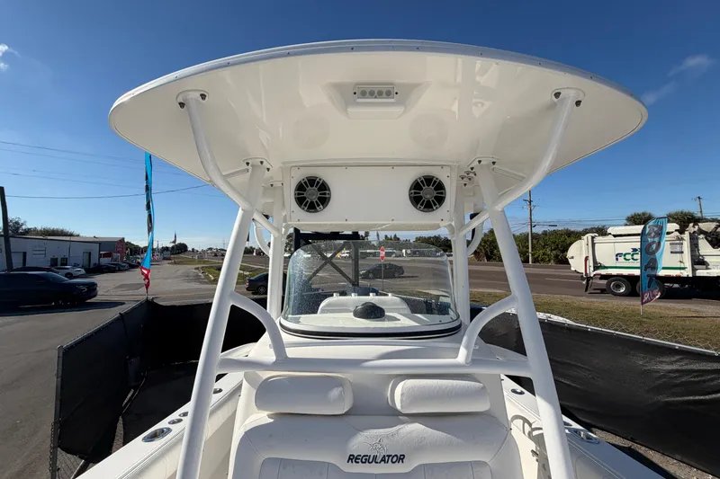 Slide: The Image of 2013 Regulator 24 Forward Seating boat interior with white cushioned seats. - 72