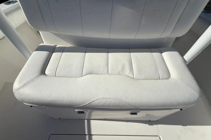 Slide: The Image of 2013 Regulator 24 Forward Seating boat interior with storage compartment open. - 74