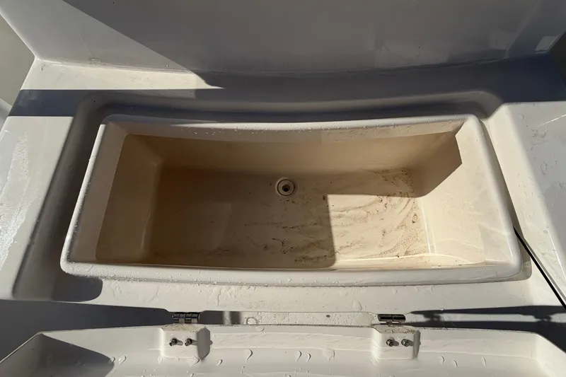 Slide: The Image of 2013 Regulator 24 Forward Seating boat interior with steering wheel and seating. - 76