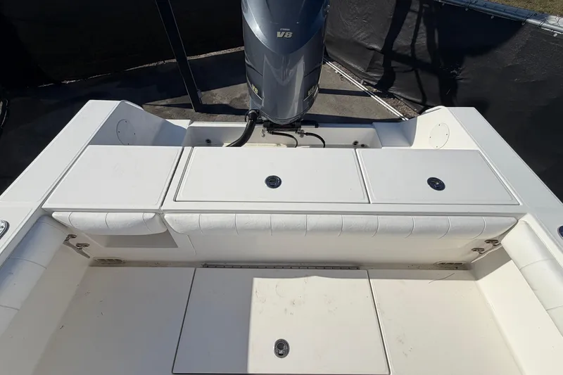 Slide: The Image of 2013 Regulator 24 Forward Seating boat interior with cushioned seating and storage. - 80