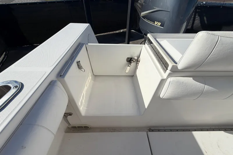 Slide: The Image of 2013 Regulator 24 Forward Seating boat interior with storage compartments and seating. - 82