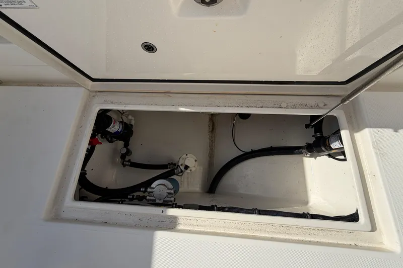 Slide: The Image of 2013 Regulator 24 Forward Seating boat with outboard motor and deck hatch. - 85