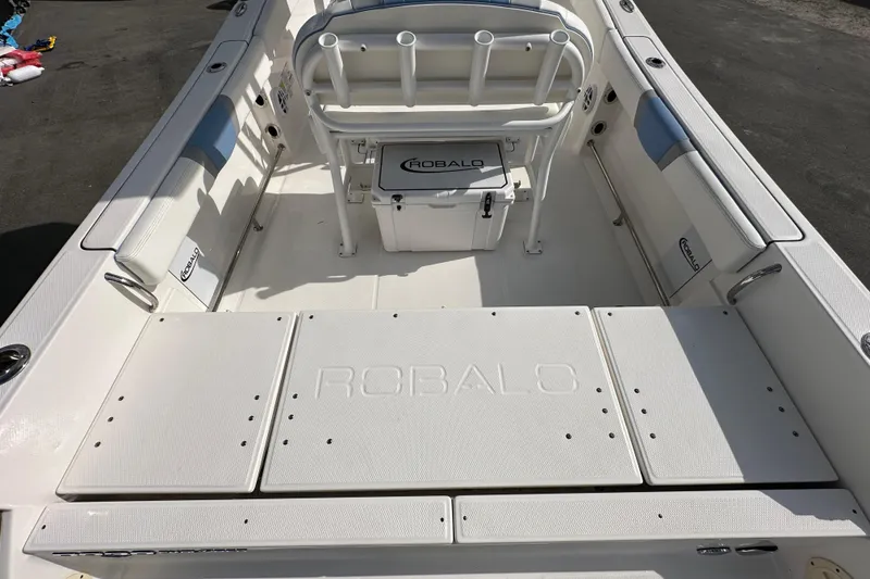 Slide: The Image of 2024 Robalo R232 Explorer boat interior with seating and storage compartments. - 10