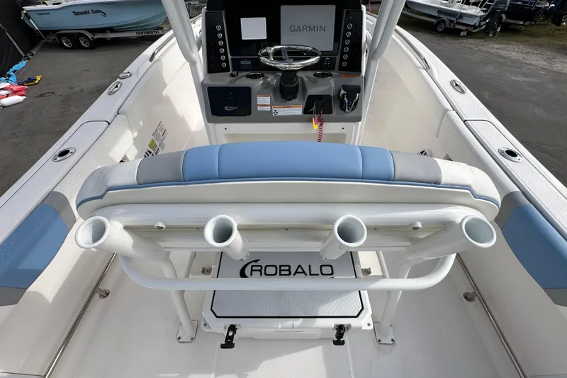 Slide: The Image of 2024 Robalo R232 Explorer boat interior with Garmin navigation system and rod holders. - 11
