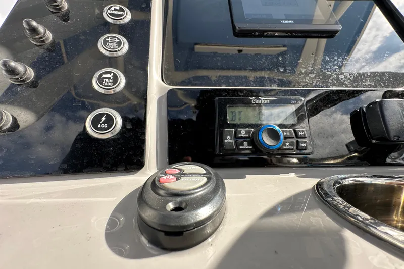 Slide: The Image of 2024 Robalo R232 Explorer dashboard with controls and Clarion audio system. - 19