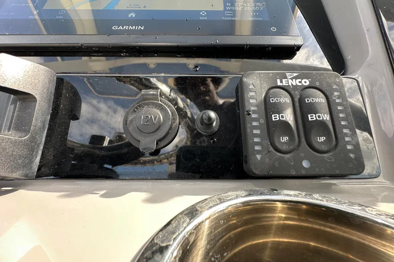 Slide: The Image of Control panel of 2024 Robalo R232 Explorer with Garmin display and Lenco trim tabs. - 23