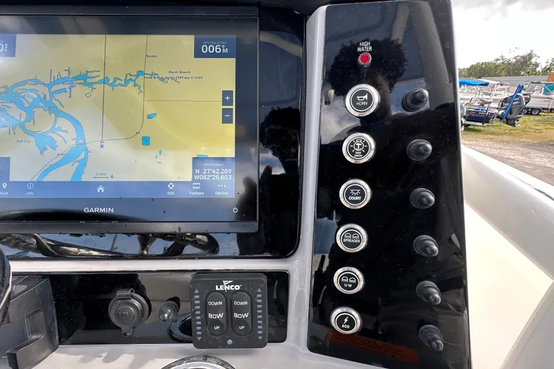Slide: The Image of 2024 Robalo R232 Explorer dashboard with Garmin GPS and control panel. - 25