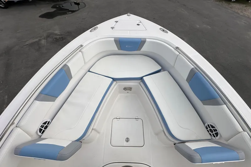 Slide: The Image of 2024 Robalo R232 Explorer boat interior with white and blue seating. - 29