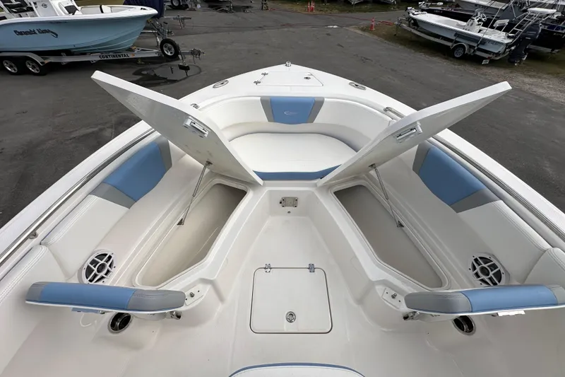 Slide: The Image of 2024 Robalo R232 Explorer boat interior with open storage compartments and seating. - 30