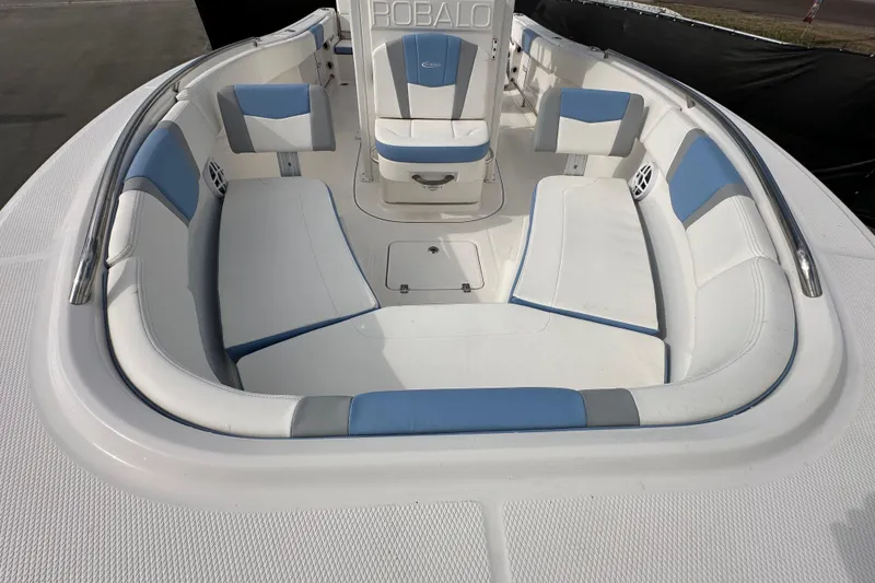 Slide: The Image of 2024 Robalo R232 Explorer boat interior with white and blue seating. - 37