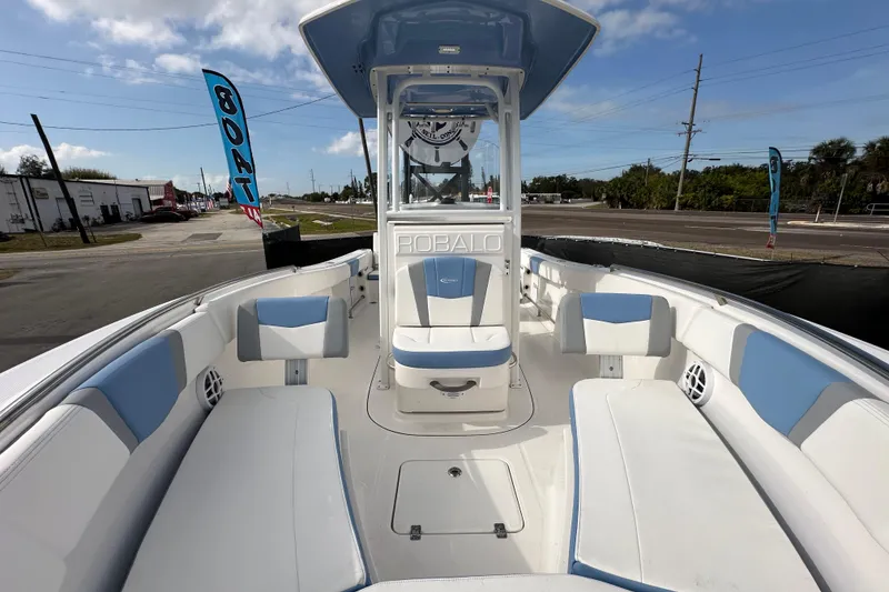 Slide: The Image of 2024 Robalo R232 Explorer boat interior with blue and white seating, outdoor display. - 38