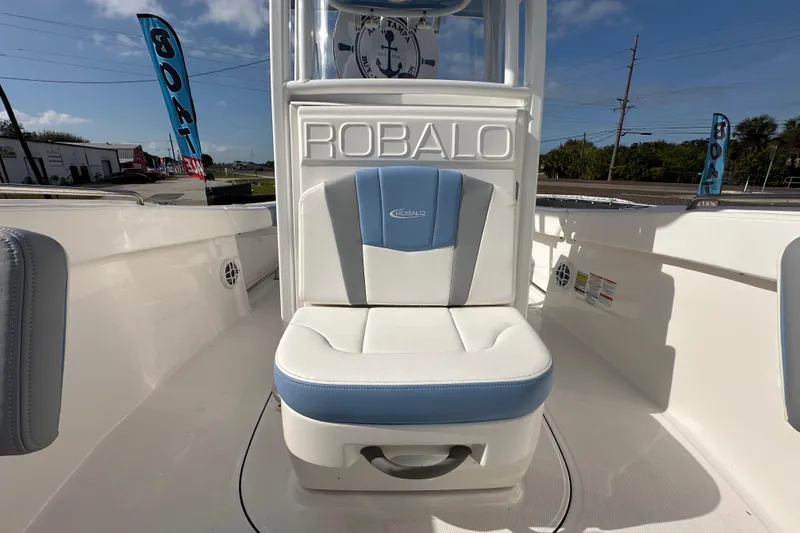 Slide: The Image of 2024 Robalo R232 Explorer boat interior with cushioned seating and branded details. - 39