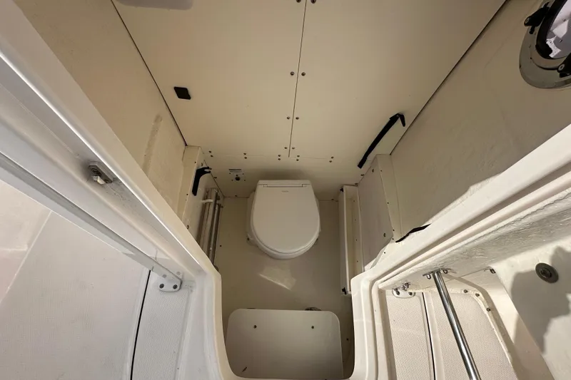 Slide: The Image of 2024 Robalo R232 Explorer boat interior with compact marine toilet. - 41
